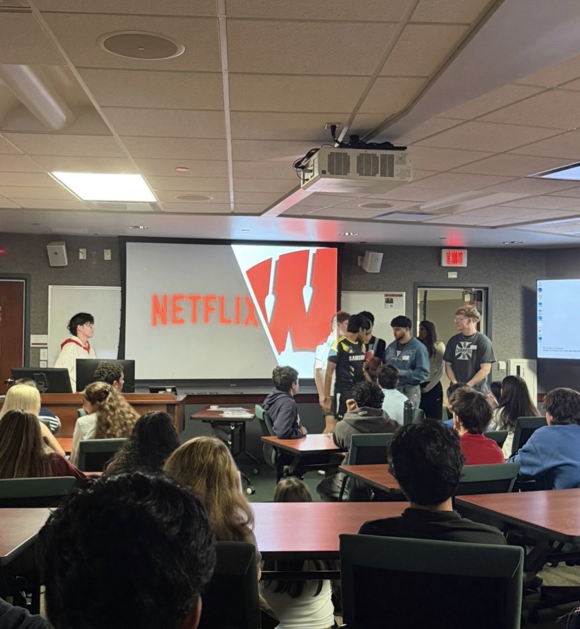 Chapter members at an event in a lecture hall